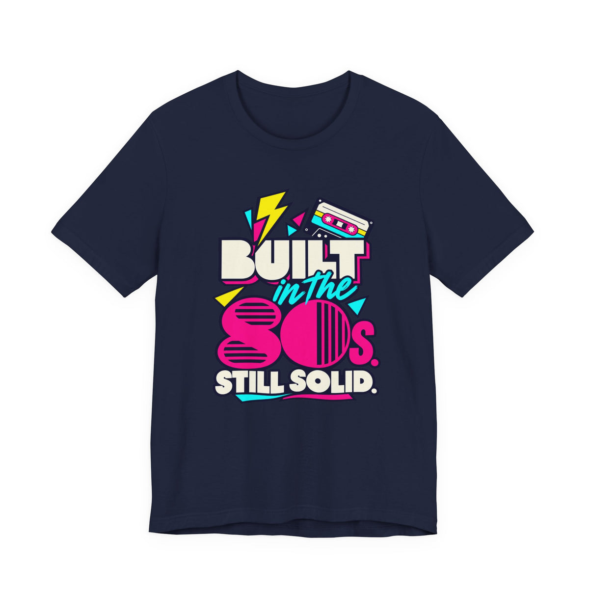 Built in the 80s. Still Solid Tee in Navy, front view with neon cassette design