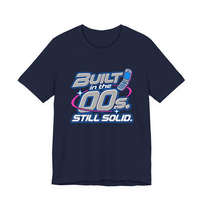Built in the 00s. Still Solid Tee in Navy, front view with Y2K chrome-style lettering