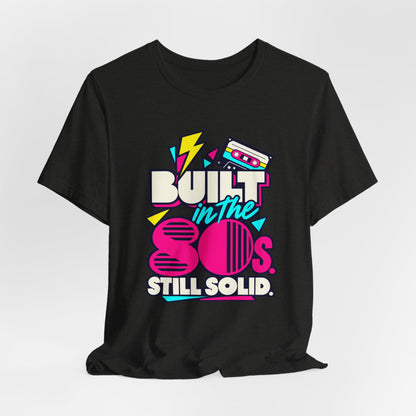 Built in the 80s. Still Solid Tee in Black Heather, styled photo