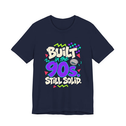 Built in the 90s. Still Solid Tee in Navy, front view with graffiti-style lettering